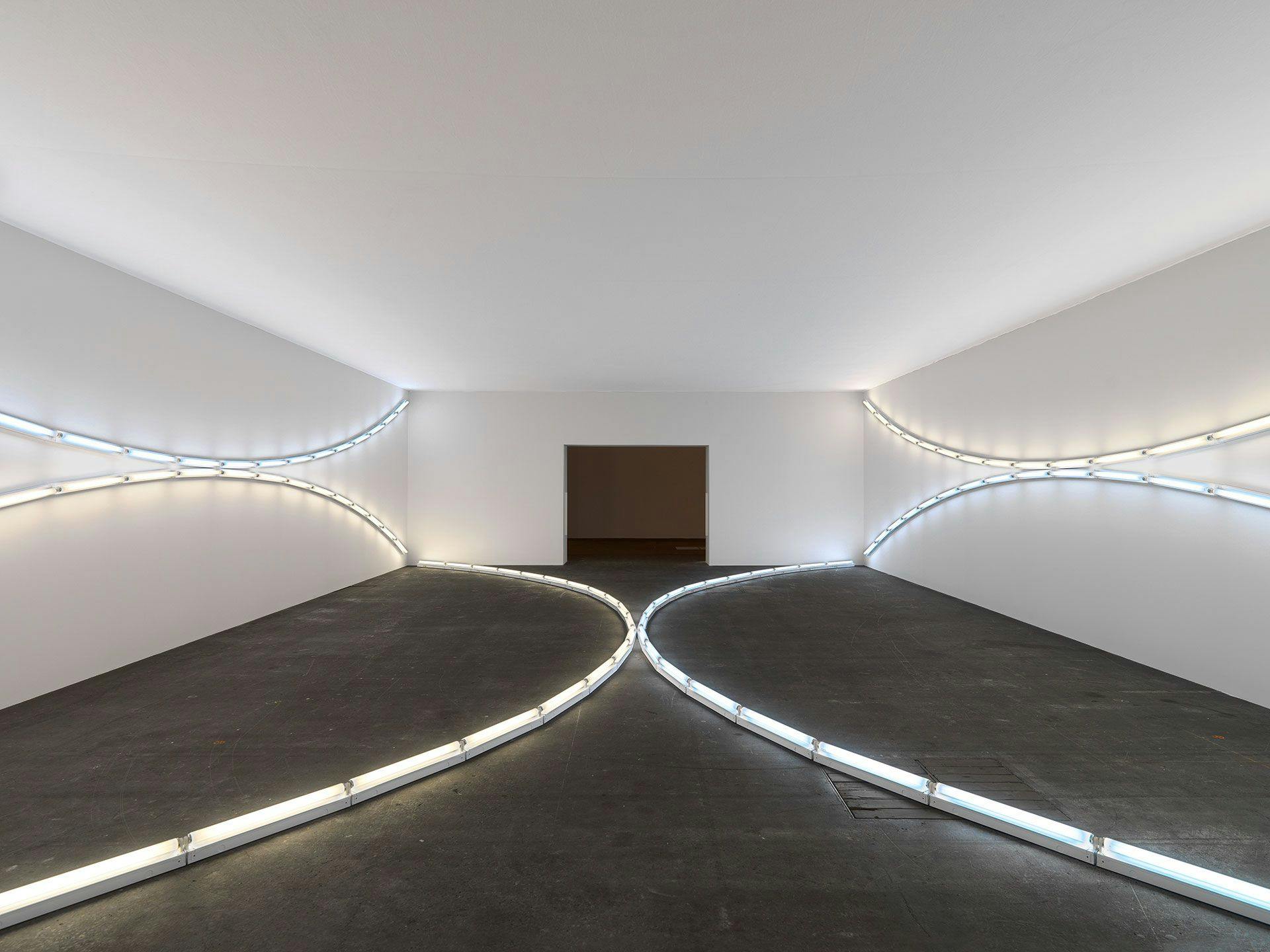 A sculpture in daylight and cool white fluorescent light by Dan Flavin, titled three sets of tangented arcs in daylight and cool white (to Jenny and Ira Licht), dated 1969.